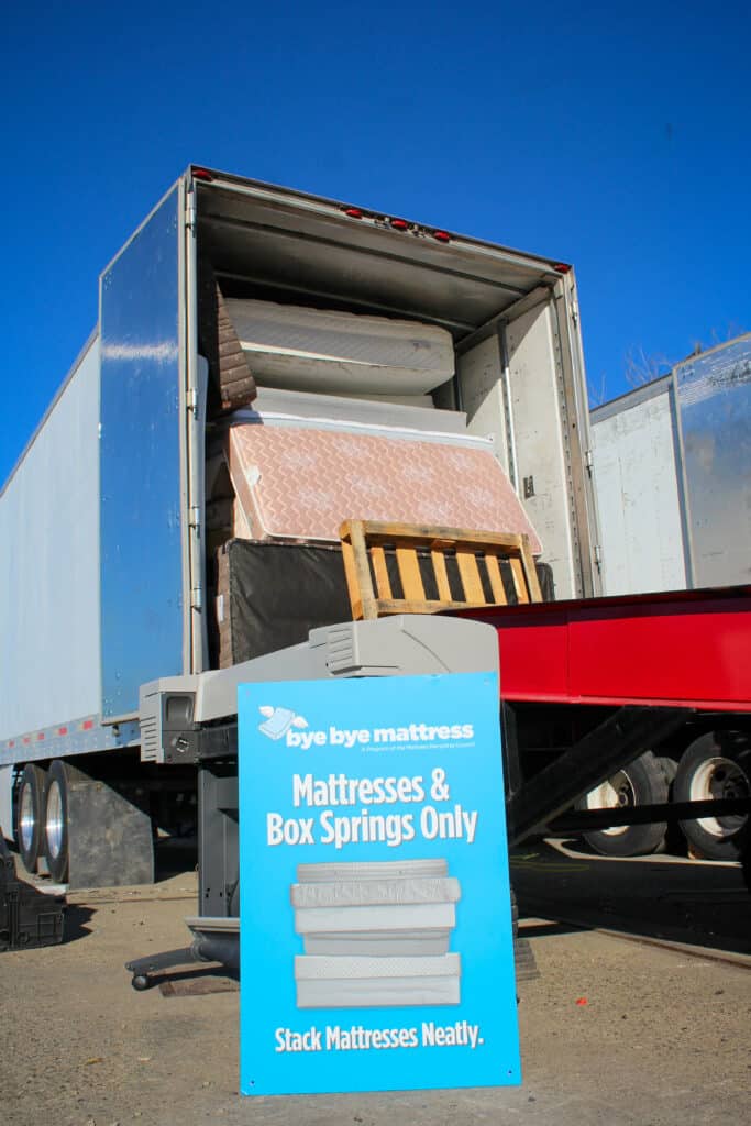 Mattresses and boxsprings loaded in trailer at a mattress collection site.