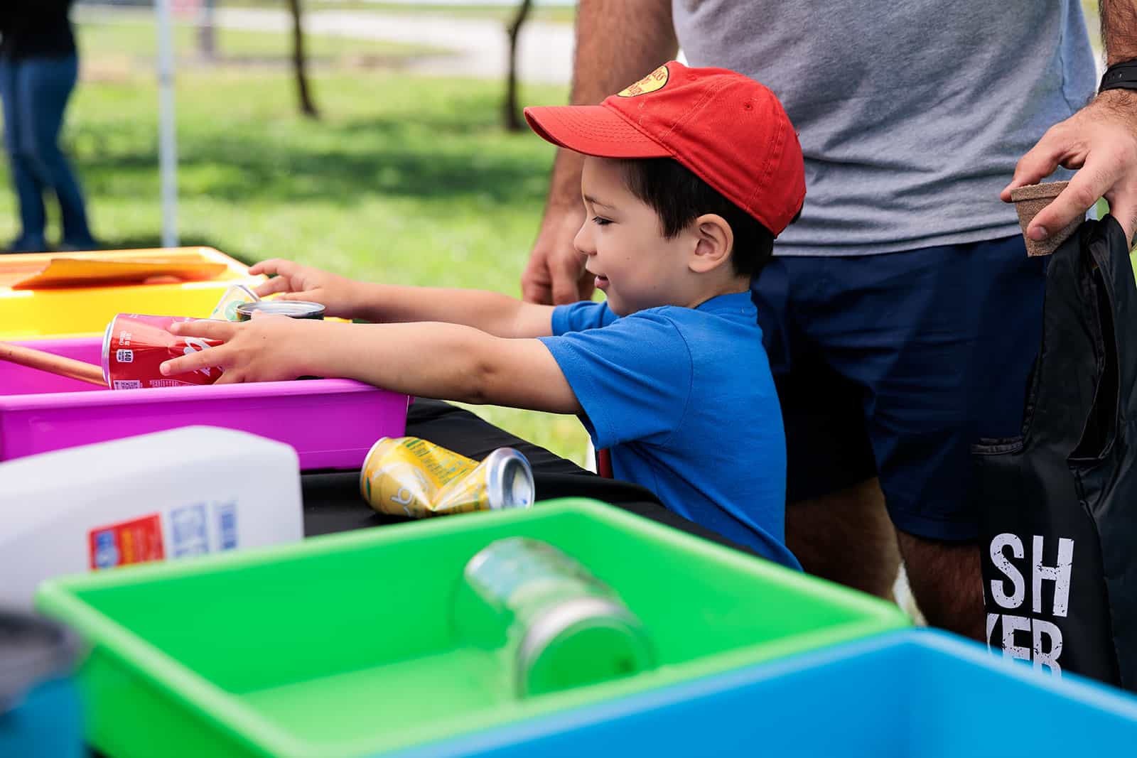 Little boy learning how to sort trash at the WPWMA Materials Recovery Facility