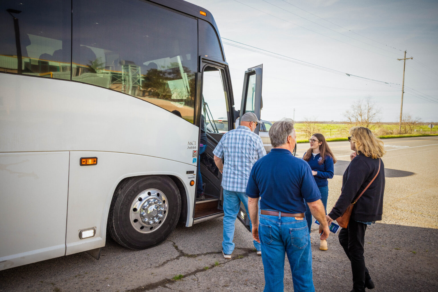 People load large white charter bus for a tour of the WPWMA's campus