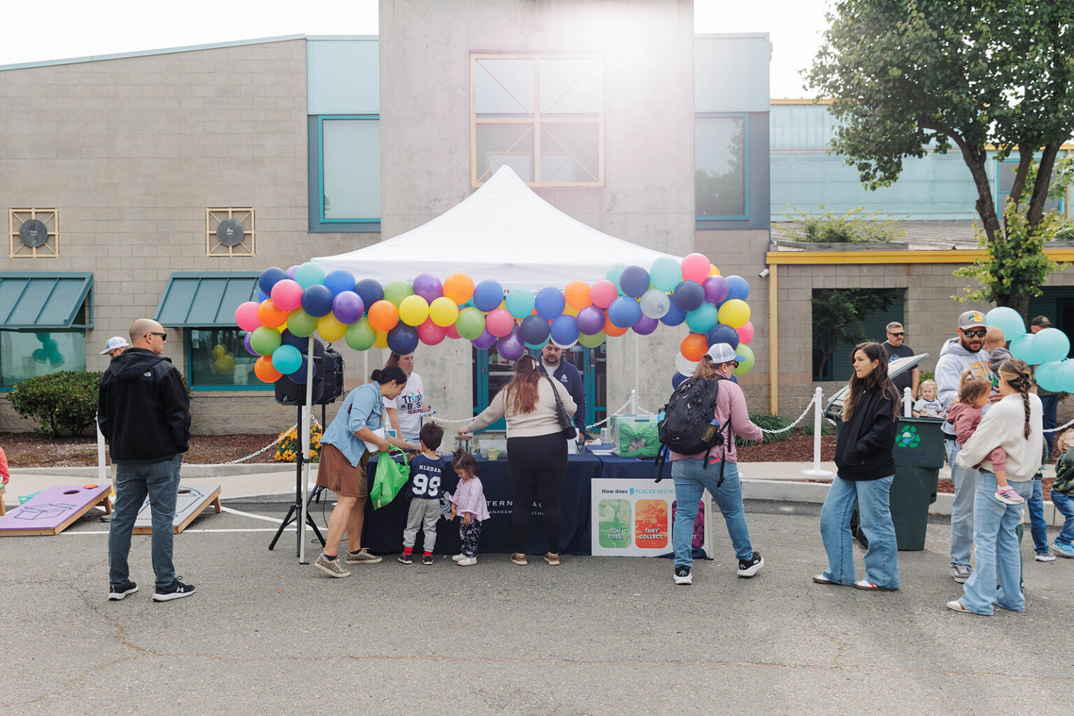 Placer Recycles' outdoor canopy tent booth decorated with multicolored balloons at the Trash Bash community event
