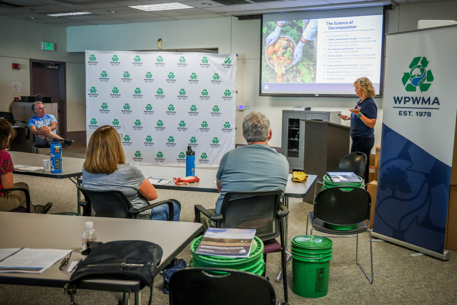 Woman presents a PowerPoint slide on the Science of Decomposition to a classroom of attendees at Compost Workshop