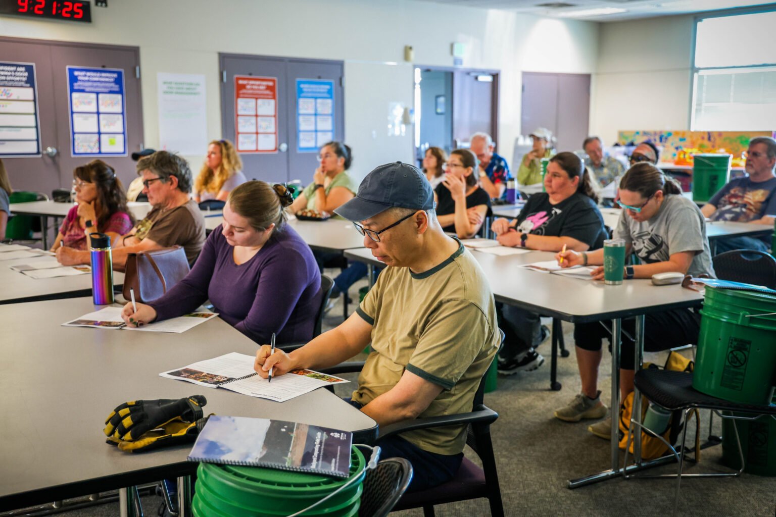 Classroom of attendees taking notes during compost workshop presentation